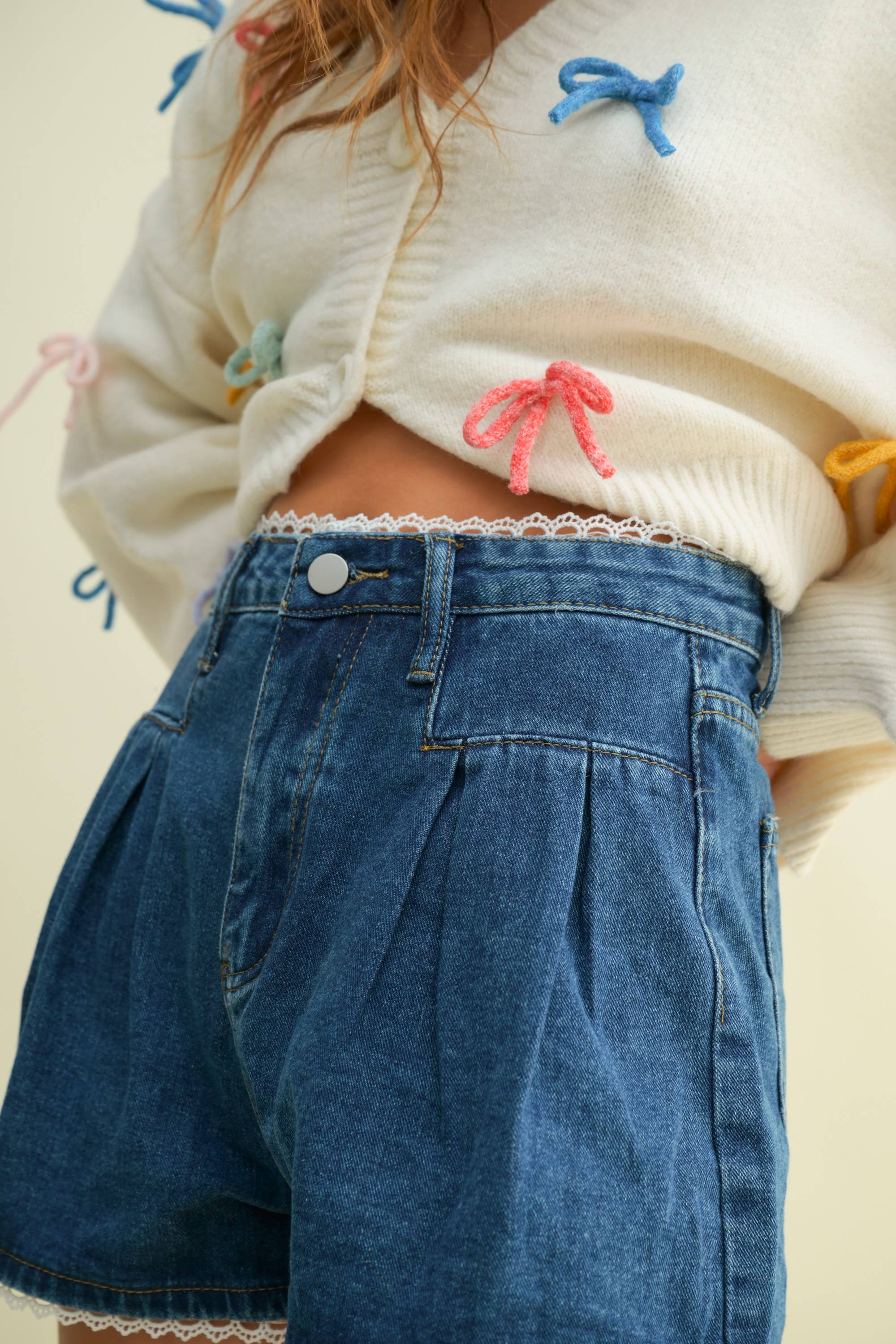 CP13470A - LACE TRIM PLEATED DENIM SHORTS for wholesale on Faire1