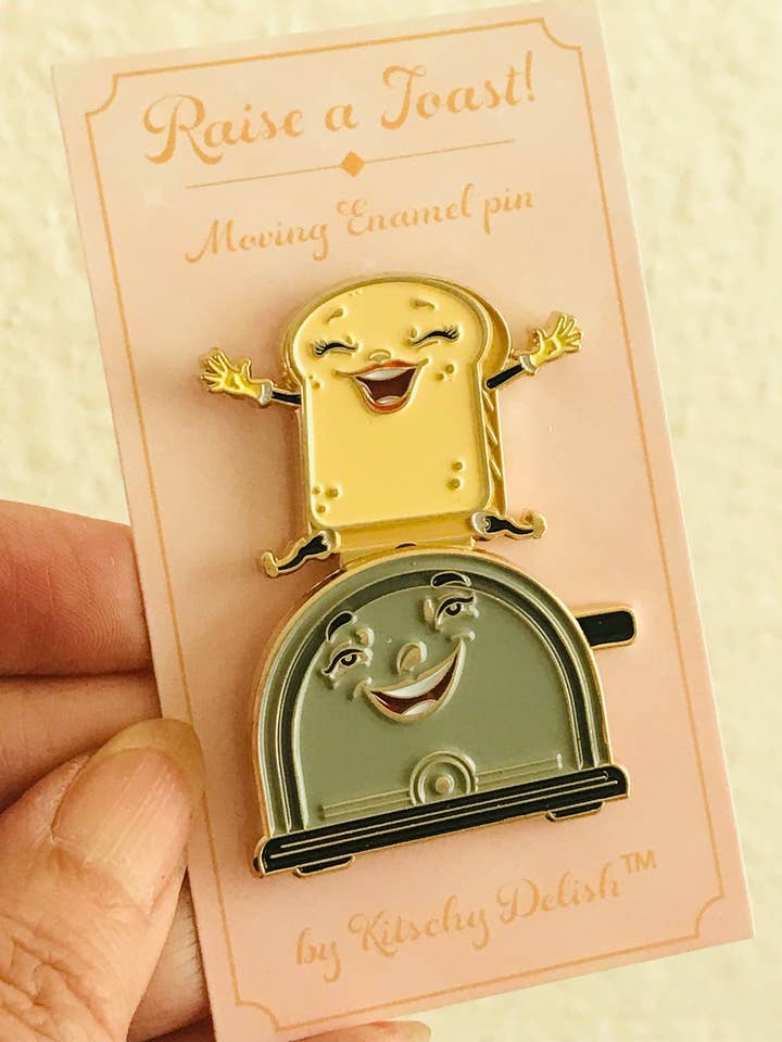 Raise a Toast, a moving enamel pin! for wholesale by Kitschy Delish