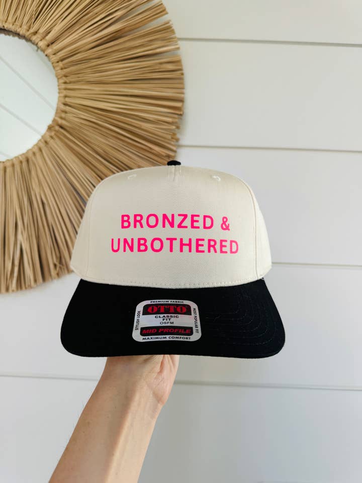 BRONZED & UNBOTHERED Trucker Hat | Black/Natural Canvas for wholesale by The Day Away Collective