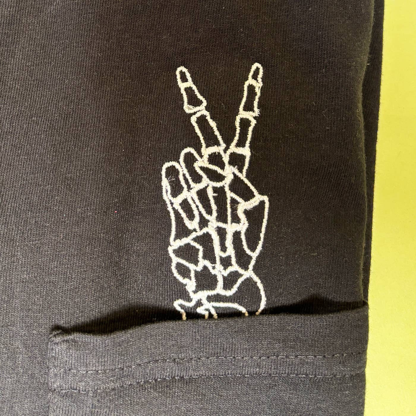 Animal Instincts - Wholesale T-Shirt - Unisex - Unisex Embroidered Skeleton Peace Hand Pocket Tee3