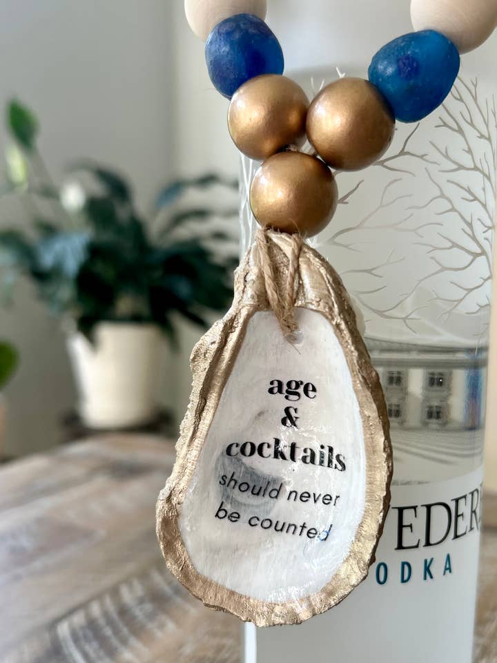 Age and Cocktails Should Never… - Liquor Bottle Charm for wholesale by Coast and Cork
