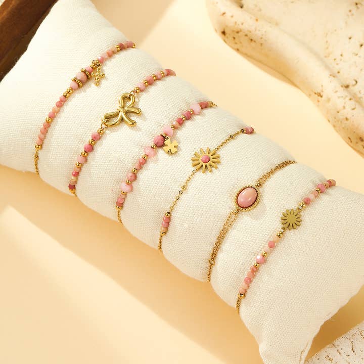 Set of 6 Gold Bracelets with Pink Beads, Flower and Bow Charms for wholesale by joya
