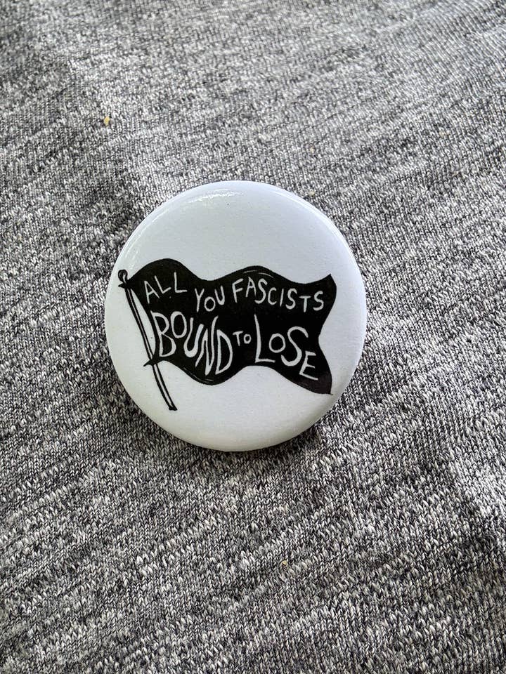 1.25" Pin - All you fascists bound to lose (Woody Guthrie)  for wholesale by Coyotesnout