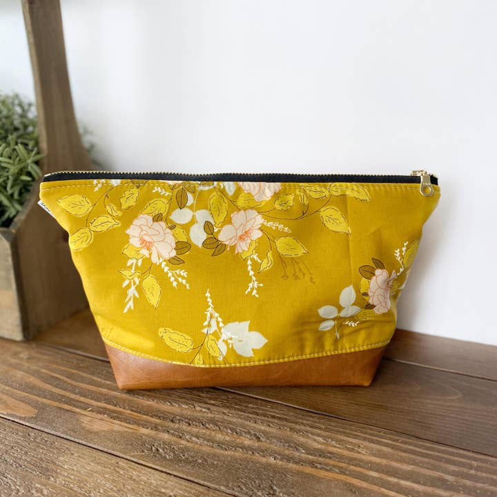 Makeup bag in sweet mustard floral for wholesale by September Skye Bags & Accessories