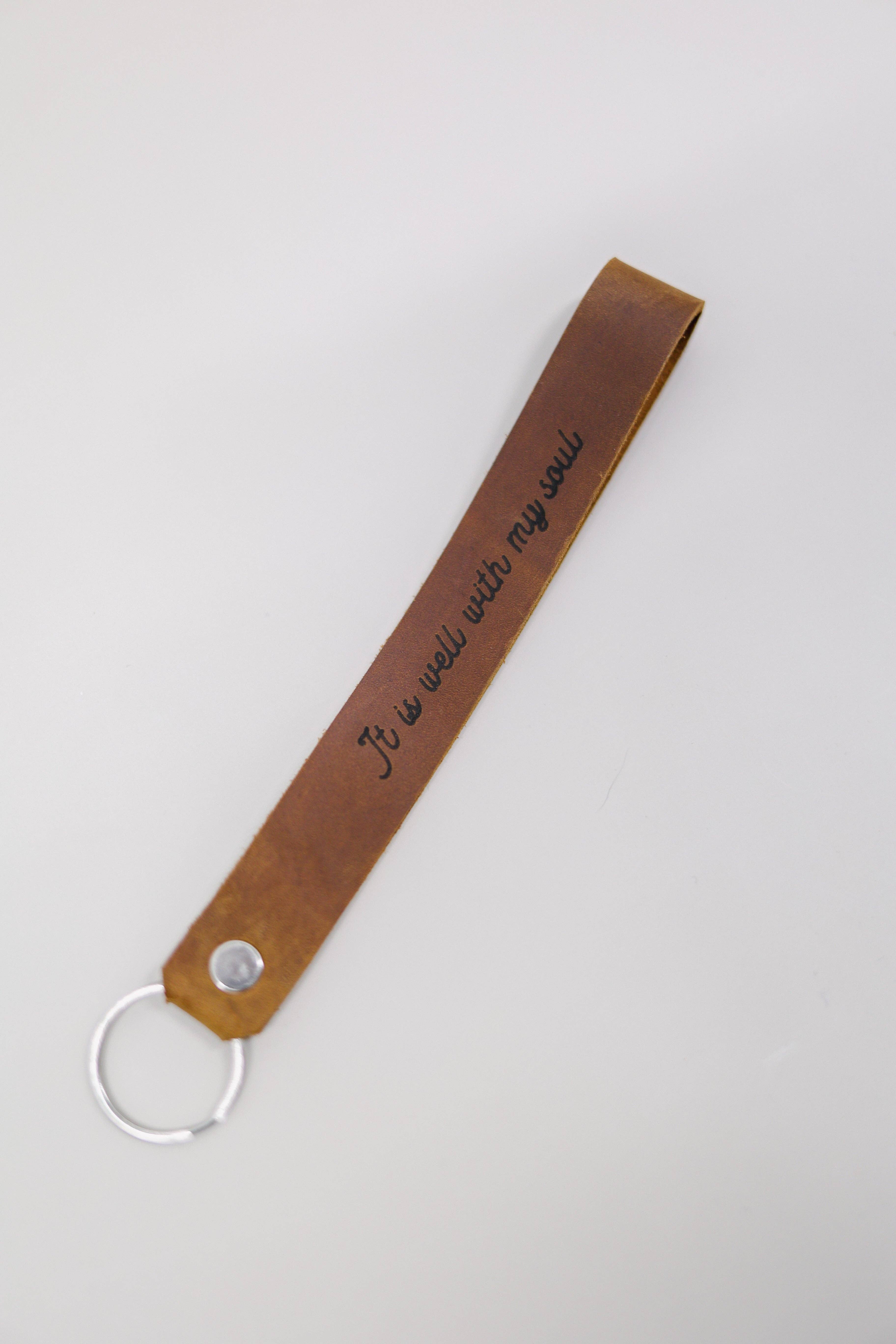 Jubilee Trading Co.  |  Ethical Trade Decor + Accessories - Wholesale Keychain - Unisex - It Is Well With My Soul Wristlet Engraved Leather0