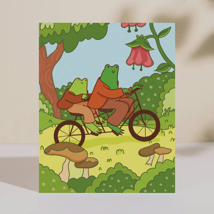 Frogs Riding a Bike Art Print for wholesale by Double Take Creative Studio