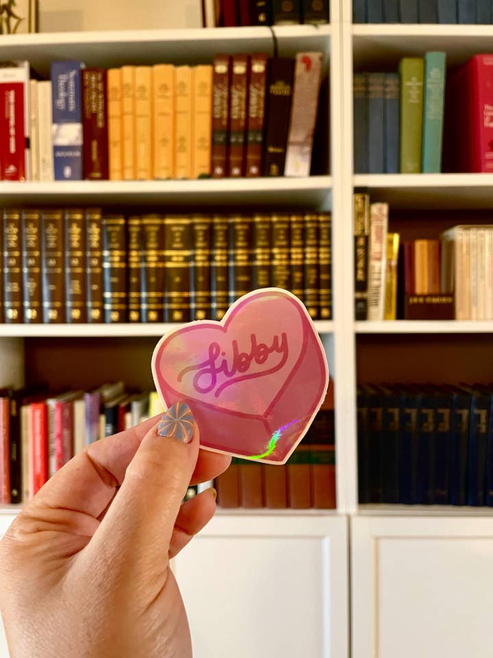 Libby Candy Heart Book Lover Holographic Sticker for wholesale by Steele Creative Co
