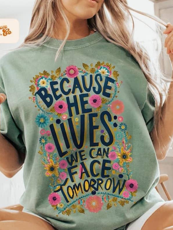 Because he lives comort colors graphic t-shirt for wholesale by The Wild Flower Boutique