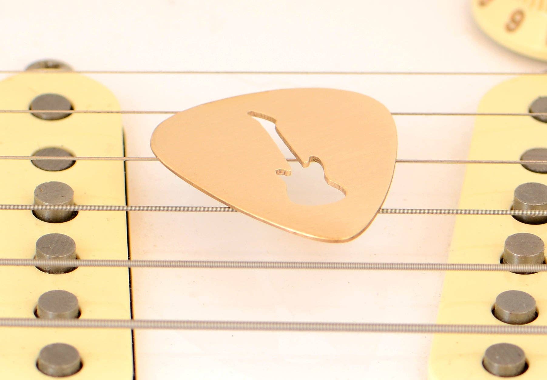 NiciArt LLC - Wholesale Music Accessory - Guitar Pick rocking out a Guitar Cut Out in Bronze4