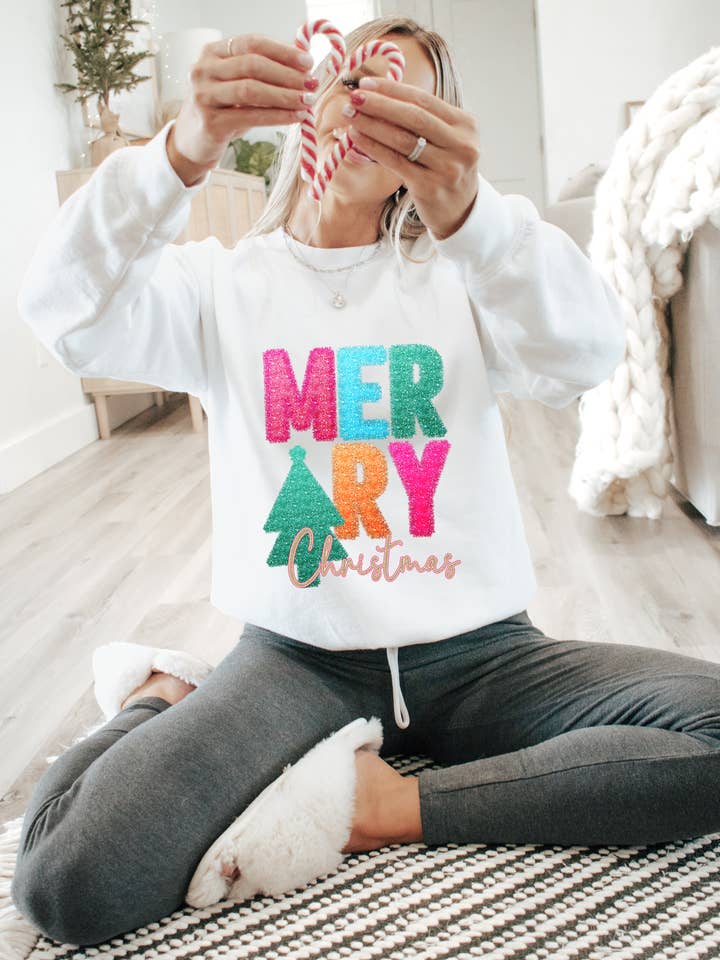 Merry Christmas tinsel design on tee or sweatshirt for wholesale by Gunpowder and lace wholesale