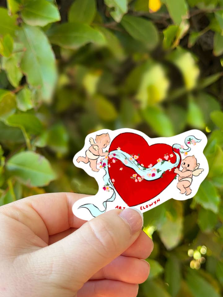 Valentinsänglar som håller ett hjärta klistermärke för wholesale av Art By Elowyn