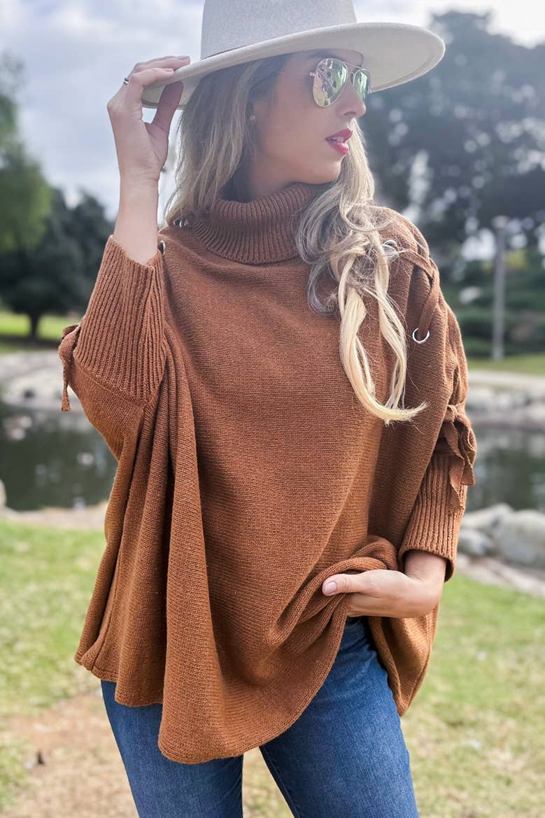 Cognac Poncho in maglia a collo alto con maniche stringate color cognac in vendita all'ingrosso su Faire6