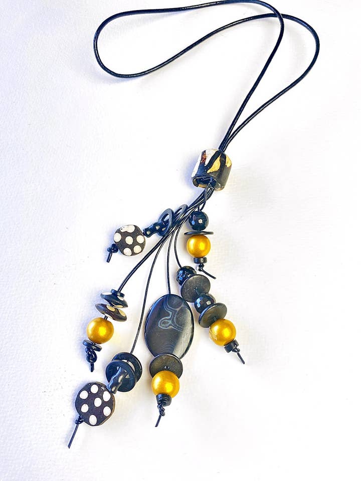 Black and gold tassel necklace for wholesale by Phyllis Clark