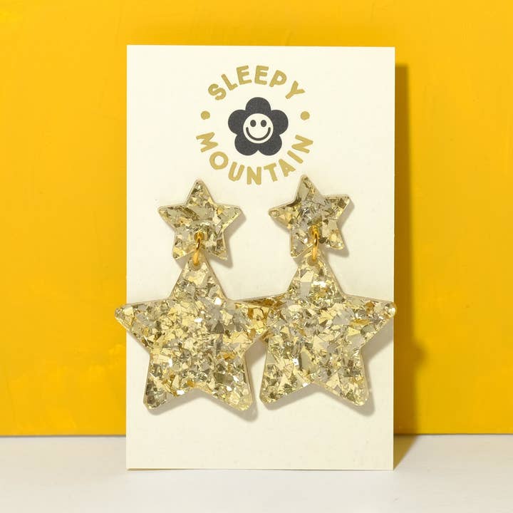 Orecchini pendenti a stella in glitter oro champagne per la vendita all'ingrosso da parte di Sleepy Mountain