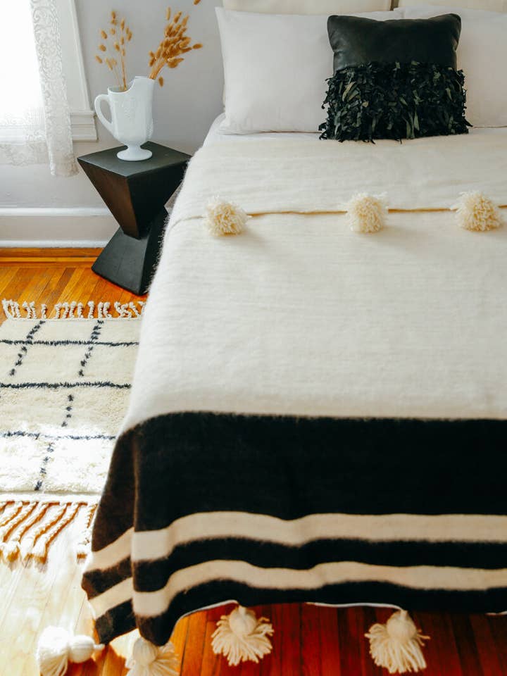 Moroccan Pom Pom Wool Blanket - White w. Black Stripe for wholesale by Ouive