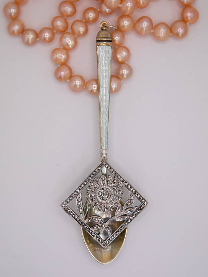 White spoon with marcasite brooch and pink pearls.
for wholesale by DecoFiniti LLC