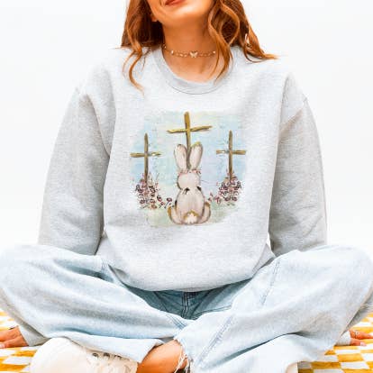 He Is Risen Bunny Sweatshirt – Faith-Inspired Easter Graphic for wholesale by Story & Grace Co