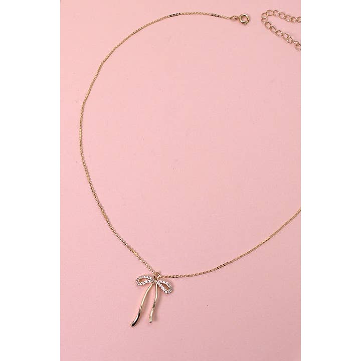 GOLD RHINESTONE BOW PENDANT NECKLACE | 80N358 for wholesale on Faire