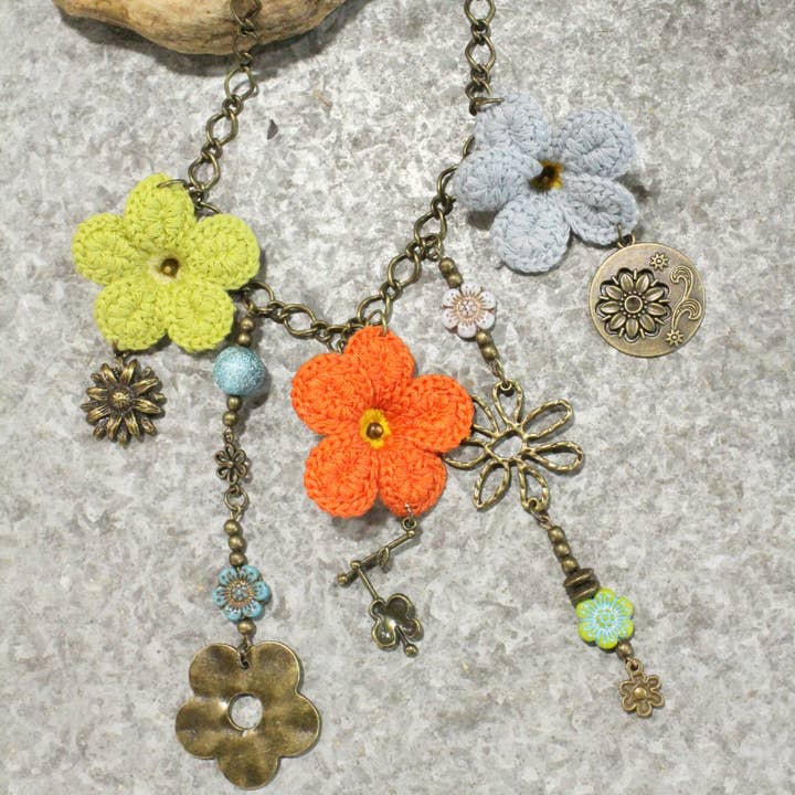 Blooming Crocheted Daisies Charmed Necklace for wholesale by The Primitive Peddler, Inc.