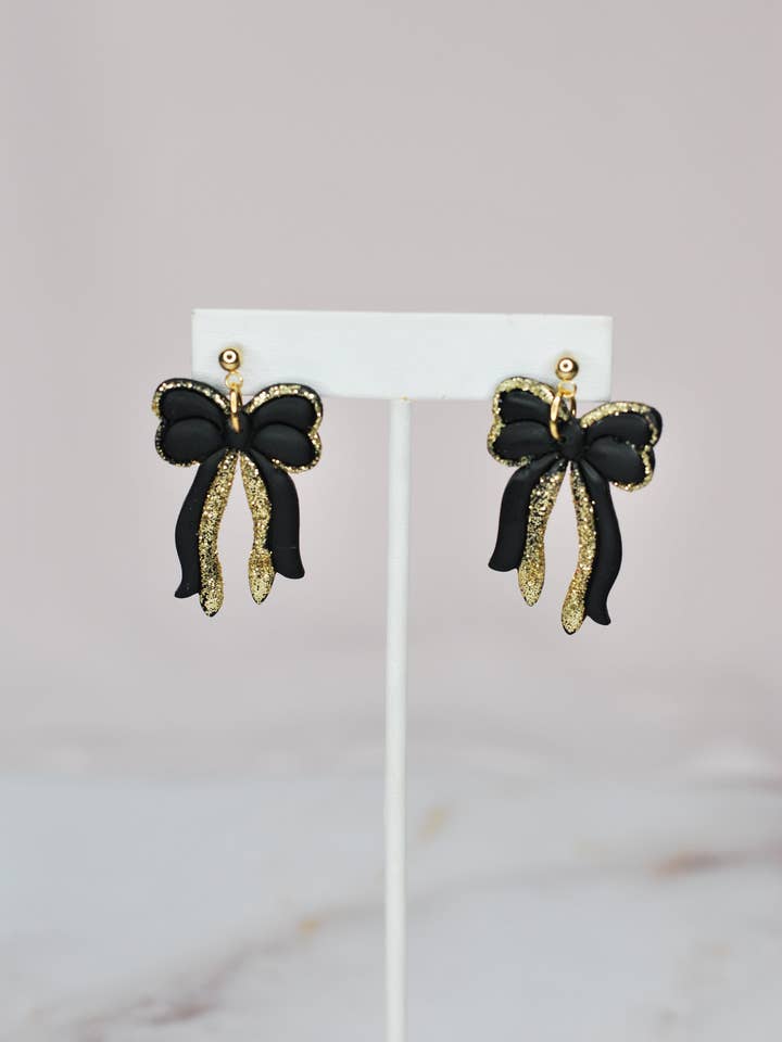 Orecchini a fiocco con glitter neri e dorati per la vendita all'ingrosso da parte di SATAZI