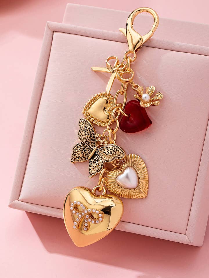 PENDENTE DE MALA - CHAVEIRO DE BORBOLETA COM LAÇO EM FORMA DE CORAÇÃO | 80K093 por atacado de JOSSLYN by wall to wall