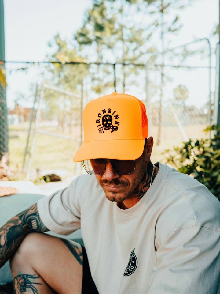 New "skull rose" blaze orange trucker for wholesale by Iron And Ink Clothing Co
