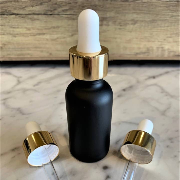 2 ounce sort mat glasflaske med hvid & guld glas dråbetæller for engroshandel hos The Bottle Shoppe