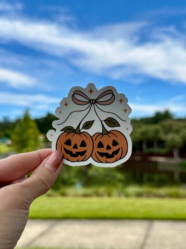 Coquette Pumpkin Jack-o’-lantern | water resistant sticker for wholesale by Tally Plant Club