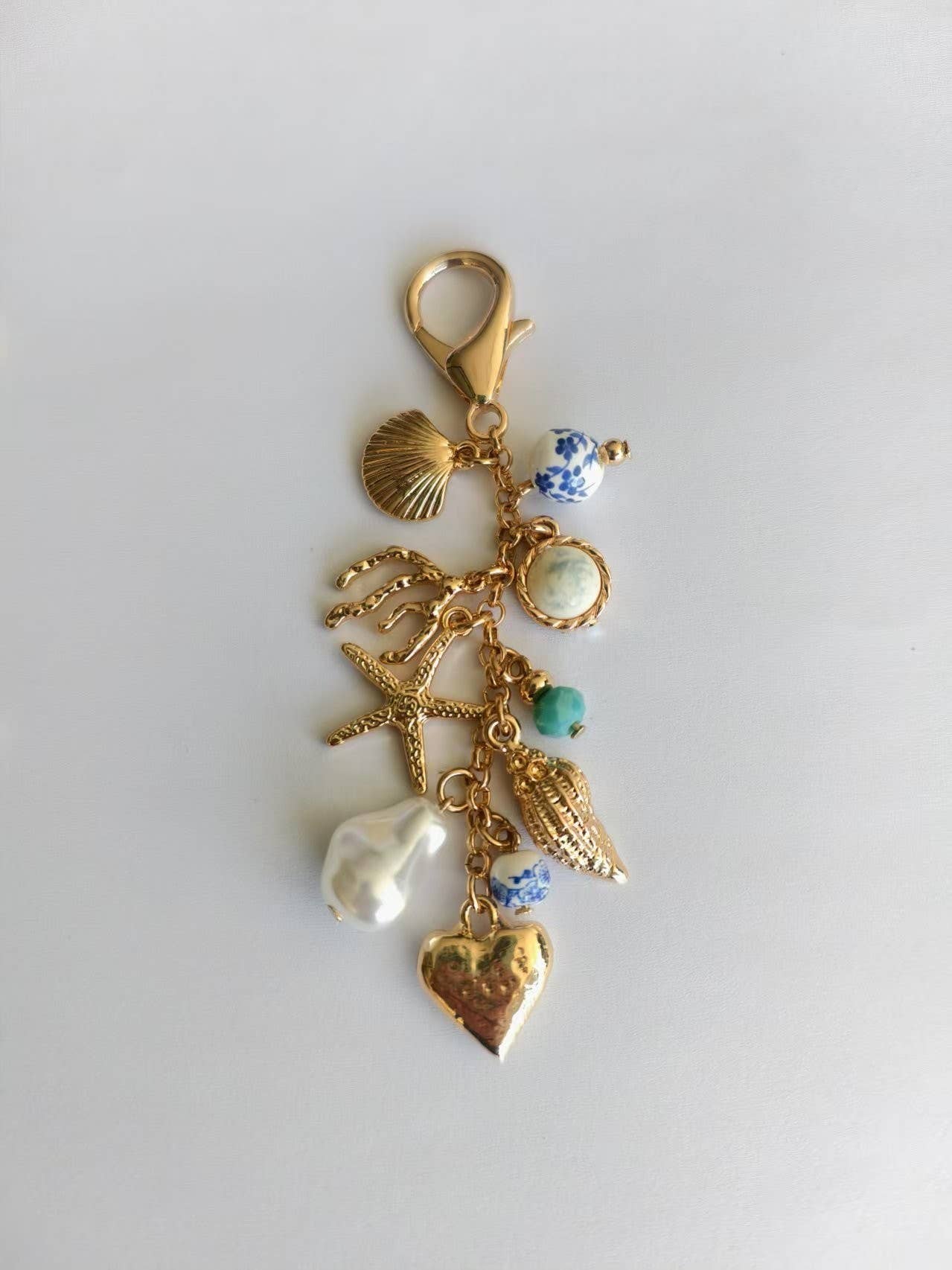 Gold PORCELAIN SEA LIFE PEARL HEART TURQ BEAD BAG CHARM | 80K009 for wholesale on Faire1
