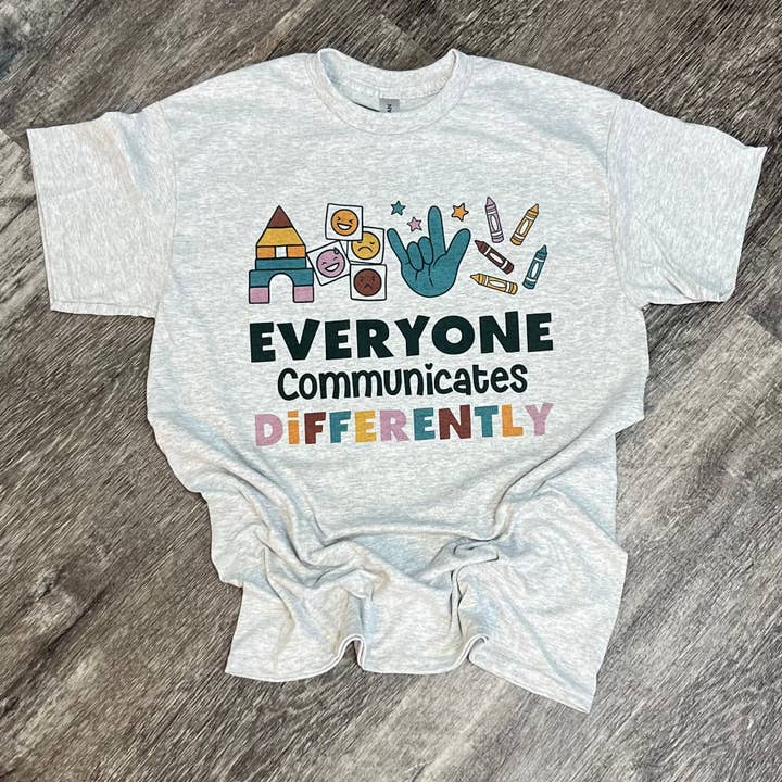 Autism Everyone Communicates Differently on Ash Gray Tee for wholesale by RMN Wholesale
