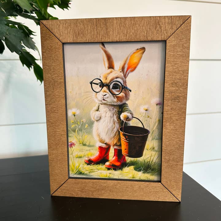 6.5x8.5” Framed Gardening Bunny in Red Boots for wholesale by Farmhouse Decor & Co.