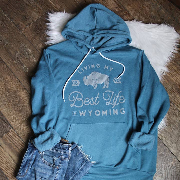 Living My Best Life in Wyoming Hooded Sweatshirt in Heather Teal for wholesale by Living My Best Life in Wyoming