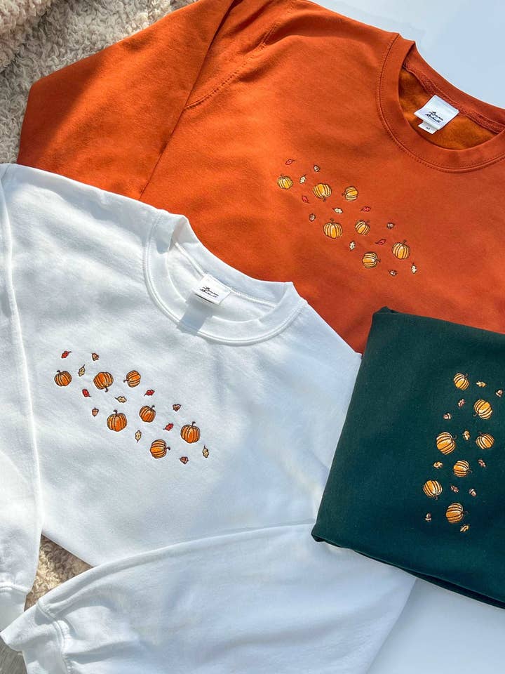 Pumpkins and Autumn Leaves Sweatshirt for wholesale by Laura Schult Design