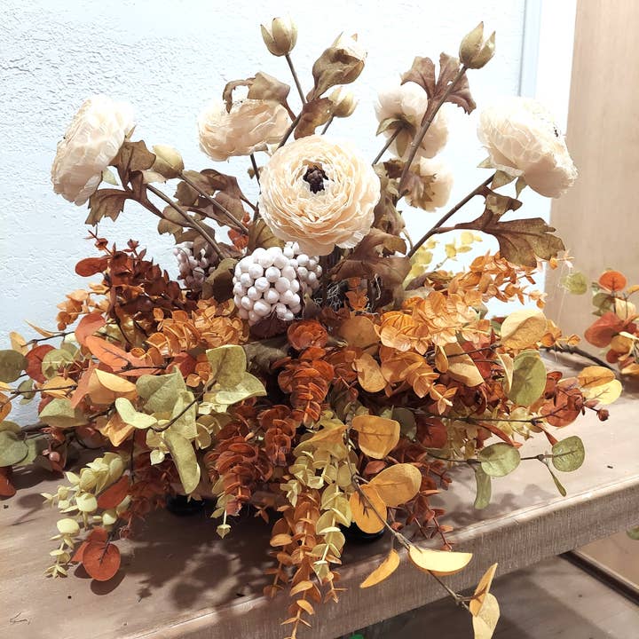 Ranunculus, Pod Berry Spray, and Eucalyptus Centerpiece for wholesale by An Array of Wreaths, LLC