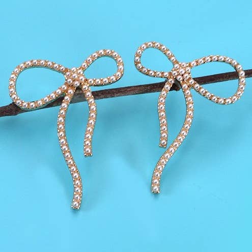 Gold BIG BOW PEARL STUD EARRINGS | 31E24163 for wholesale on Faire