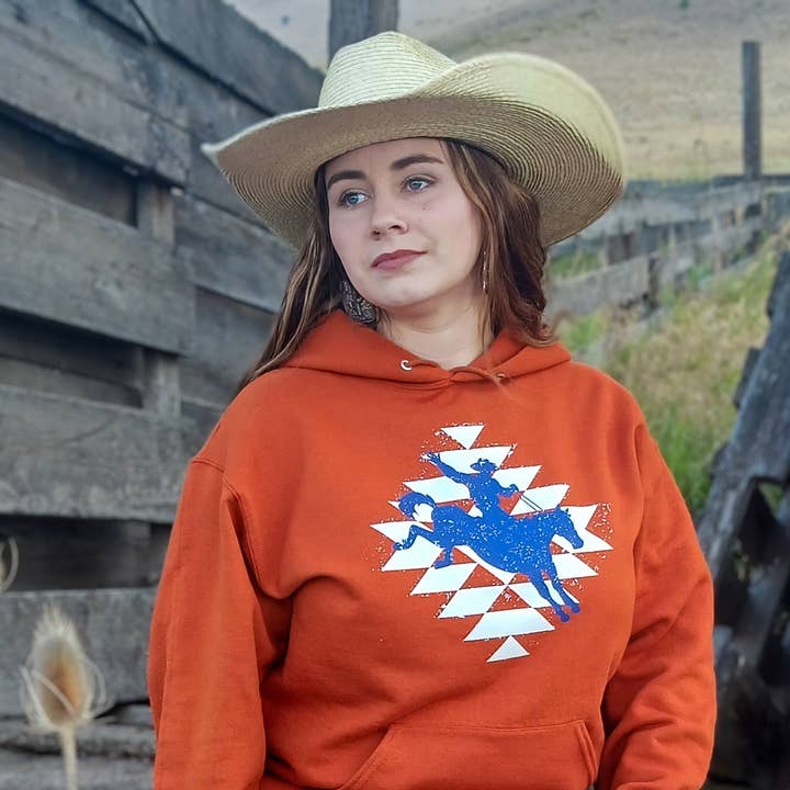 Aztec Bronc Riding Cowboy Hoodie – Dark Autumn Orange for wholesale by Prairie City Apparel