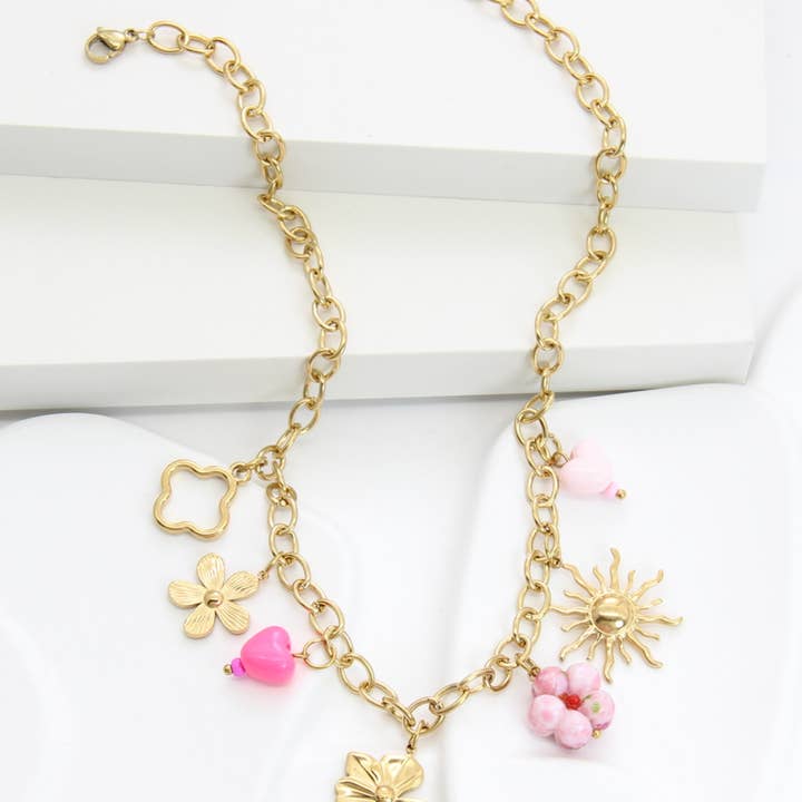 Pink Gold stainless steel necklace with flower, heart, and sun charms for wholesale on Faire0