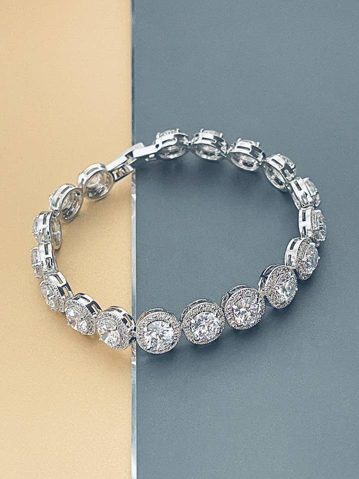 ONEIDA - 7" større runde CZ sten i små runde CZ indstilling armbånd i sølv for engroshandel hos JohnnyB Jewelry