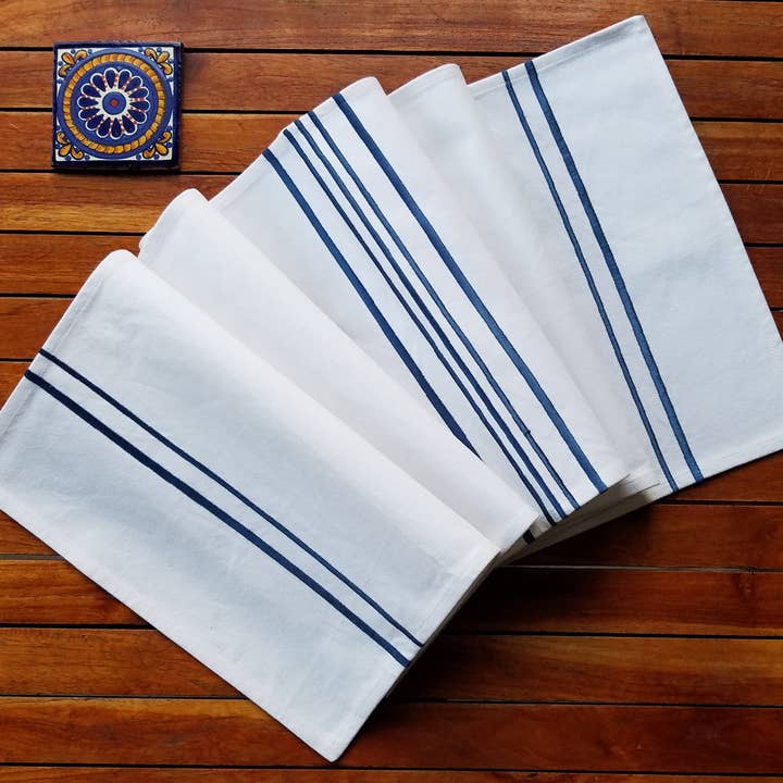 White cotton table runner embroidered with blue vertical lin for wholesale by Indigostep