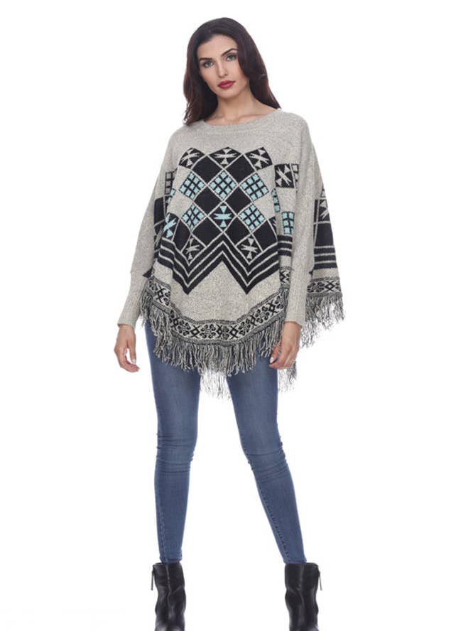 Poncho con frange da donna (KF2982) per la vendita all'ingrosso da parte di Rising International Inc