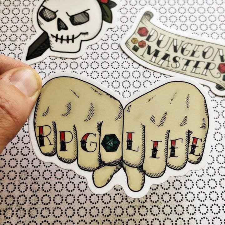Storymakers Trading Co. - Wholesale Phone & Laptop Stickers - RPG life tattooed knuckles - tattoo flash style vinyl sticker - waterproof, UV-proof