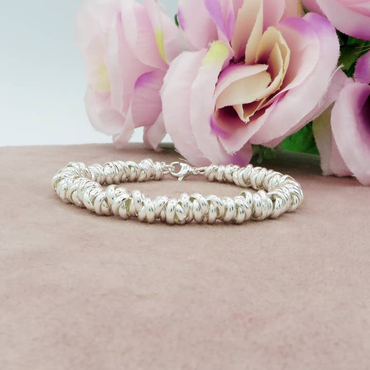 NODINI bagnato ARGENTO ~ UNISEX Armband aus EDELSTAHL mit Ringen und Knoten für den Großhandel von Daemon srls