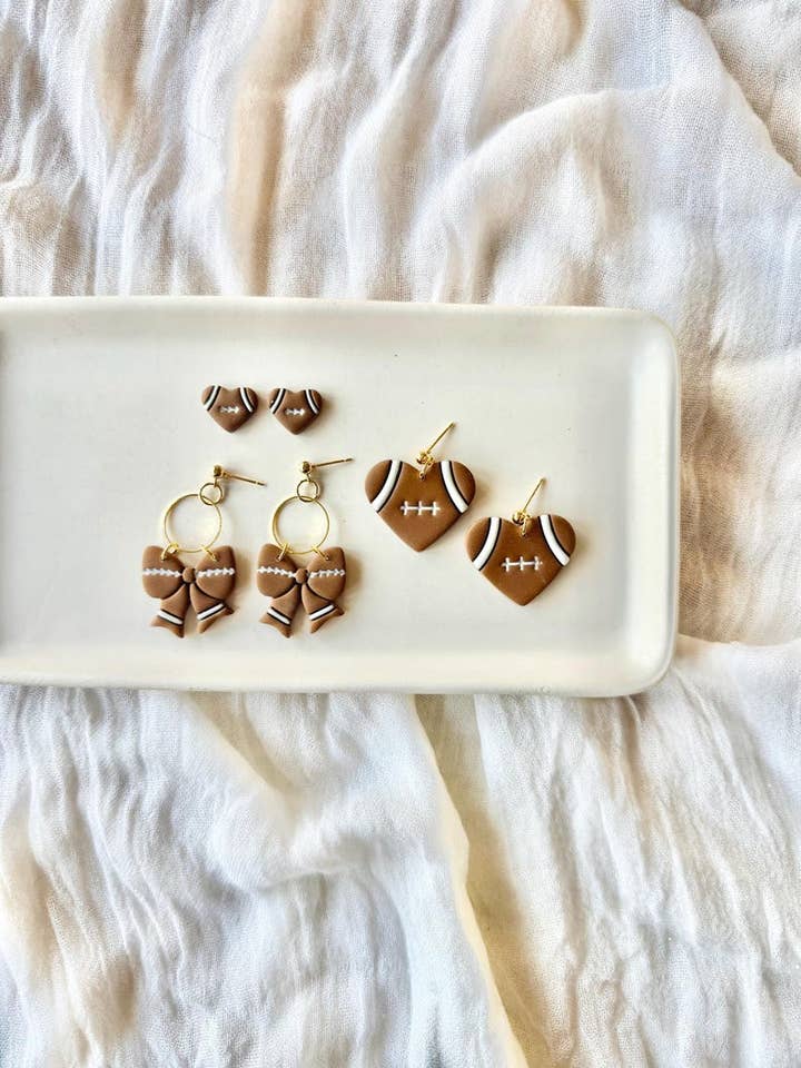 Football Earrings, Football Clay Earrings, Football Heart Studs, Football Bow Earrings, Sports Bow Earrings, Football Mom Studs for wholesale by SeizeTheClayJewelry