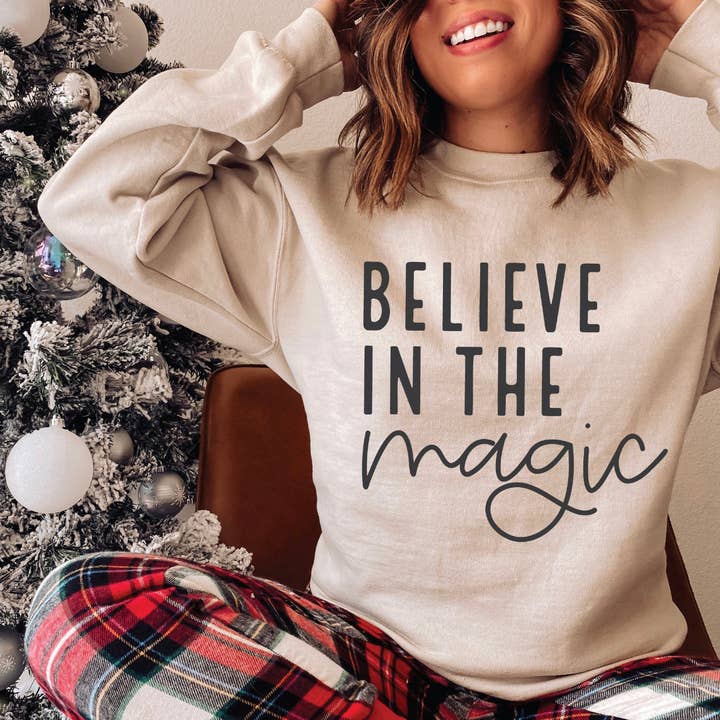 Believe in the Magic on White Sweatshirt for wholesale by Cypress Slough Outfitters