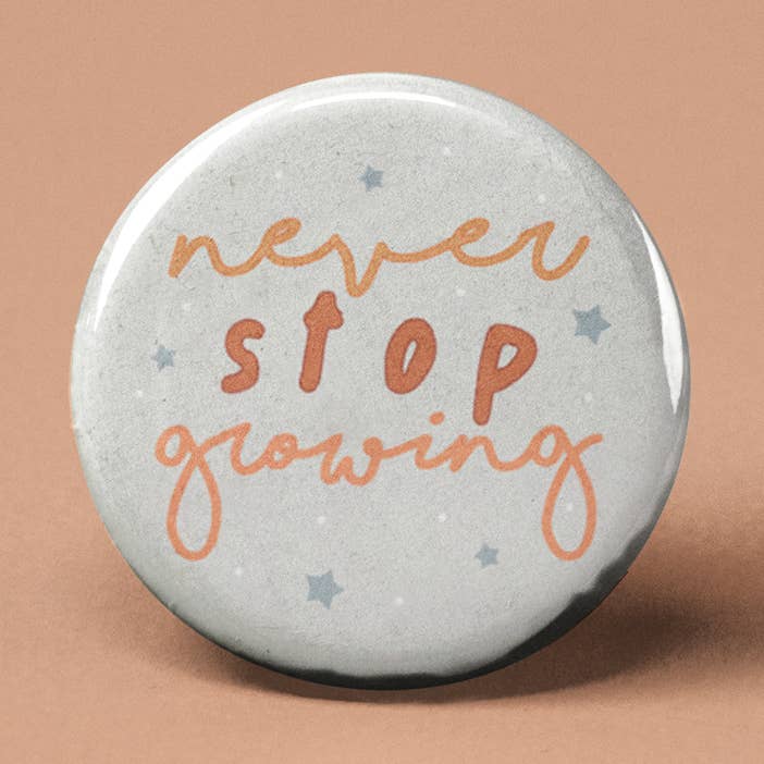 Never Stop Growing Pinback Button for wholesale by The Pin Pal Club
