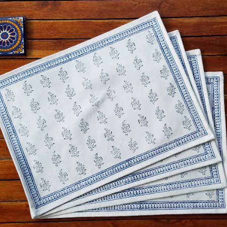 White cotton placemats hand printed with indigo paisleys for wholesale by Indigostep