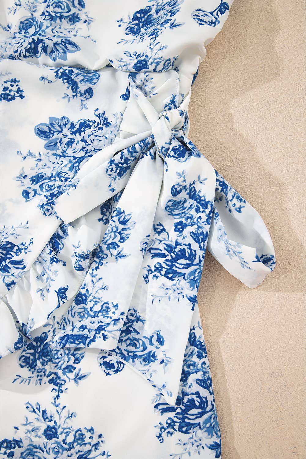 Blue Floral Print Strapless Zipped Back Knot Waist Ruffled Romper for wholesale on Faire10