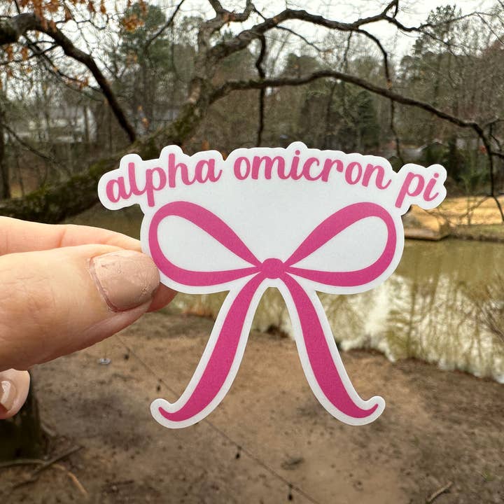 Sticker | AOP | Alpha Omicron PI Pink Bow | Waterproof Vinyl Sticker | White | Clear | Permanent | Removable | Window Cling | Glitter | Holographic for wholesale by My Vinyl Cut