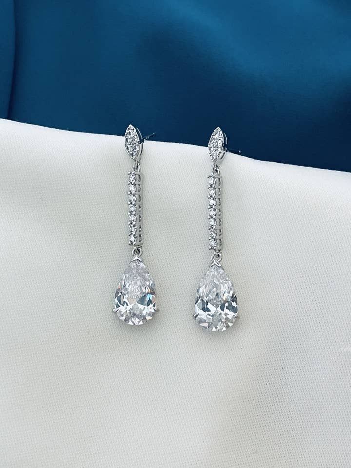 RAINE - Slender Drop Crystal Earrings In Silver for wholesale by JohnnyB Jewelry