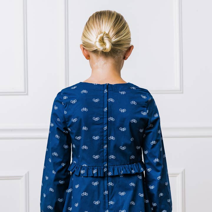 Navy Bicycle Print Ruffle Waist Dress - Made with Organic Cotton for wholesale on Faire